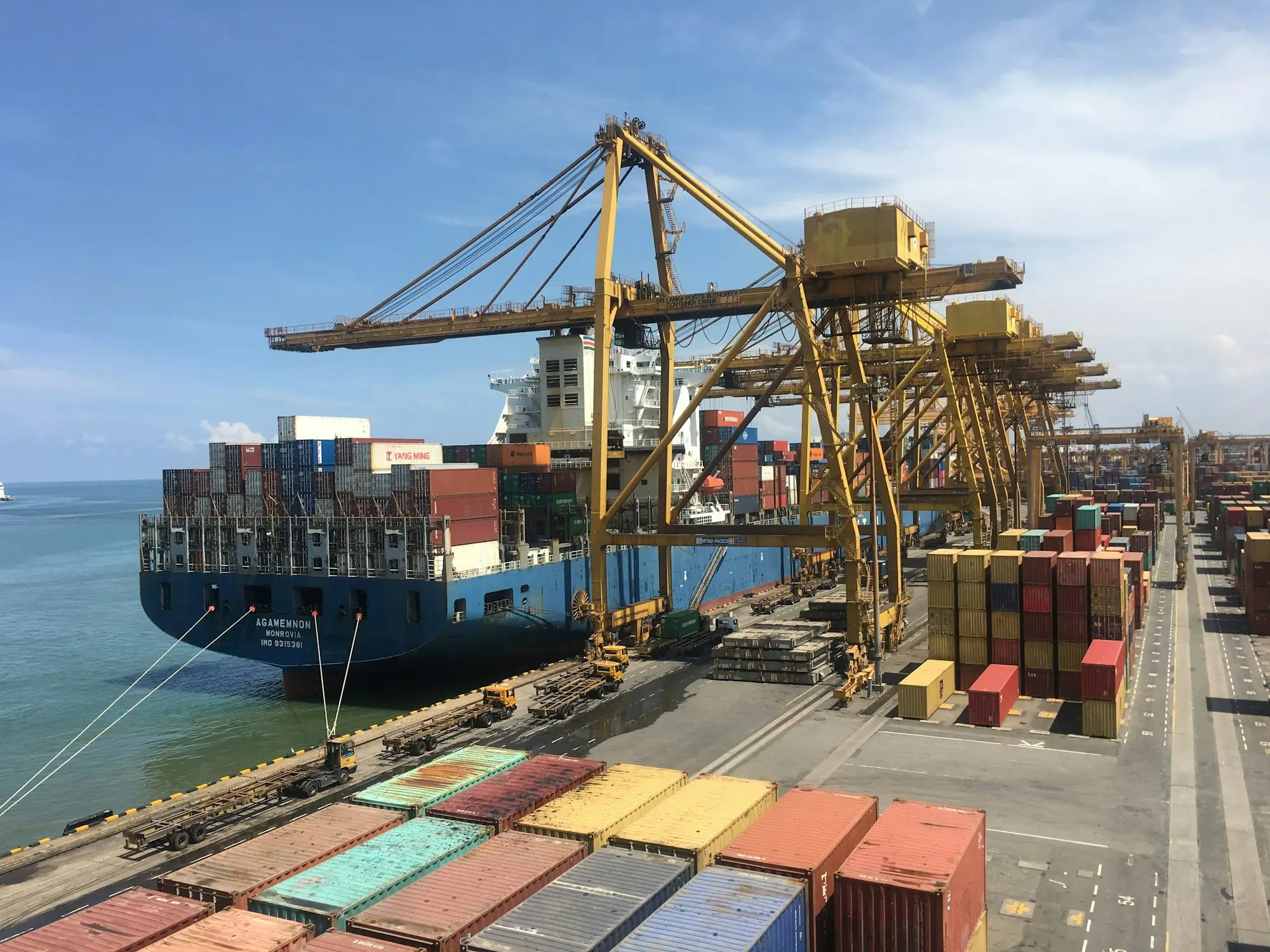 Container ship being unloaded by gantry cranes at a port, the first stock order under a new distribution agreement